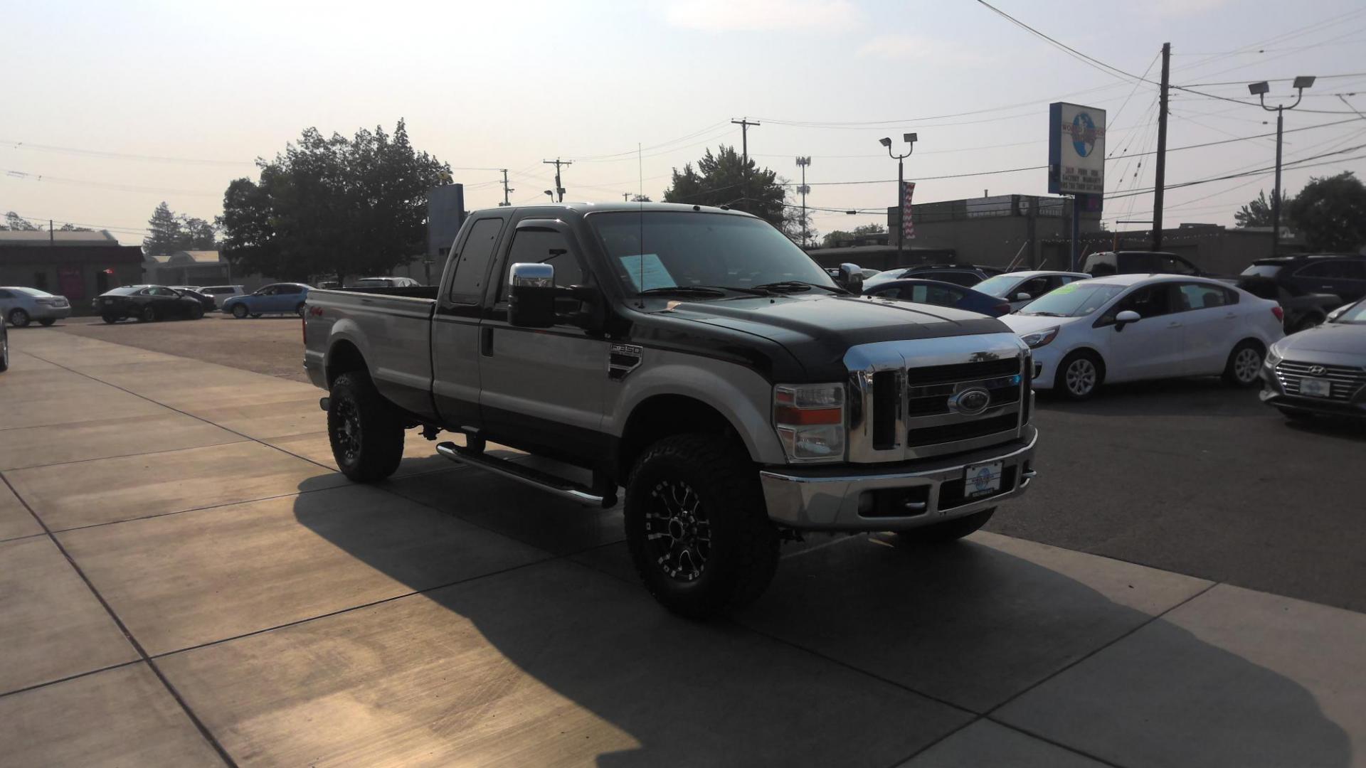 2008 BLACK Ford F-350 SD FX4 SuperCab (1FTWX31RX8E) with an 6.4L V8 OHV 32V TURBO DIESEL engine, located at 502 S. Riverside Avenue, Medford, OR, 97501, (541) 773-3136, 42.322803, -122.867477 - Check out this sweet beauty of a truck! A 2008 F-350 FX4 Lariat with 6.4L V8 Turbo Diesel PowerStroke and full 8-ft bed! Brand new tires and wheels on this two-tone paint package really pop. Leather seats, power seats, double batteries, tow package, made for work, made for play, come check it out - Photo#1